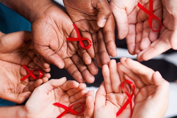 hands holding red ribbons