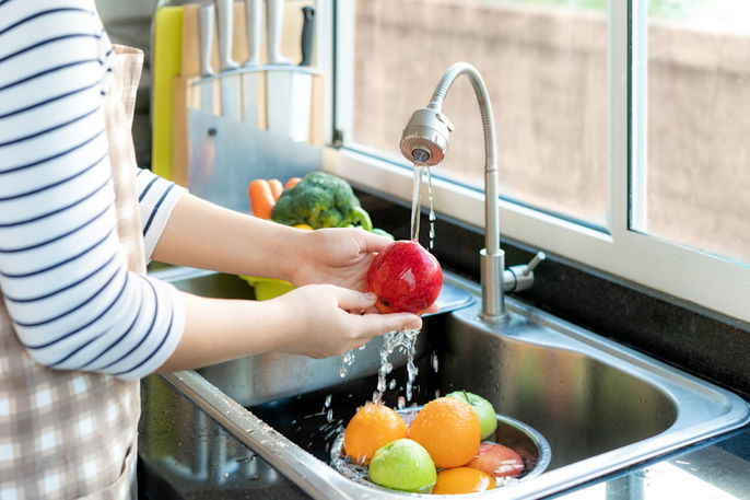 mujer lavando frutas y verduras
