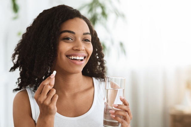 Woman taking a pill