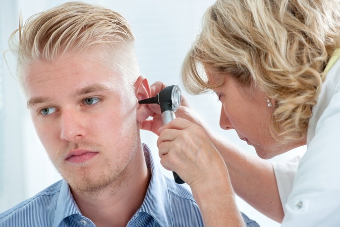Doctor assessing ear