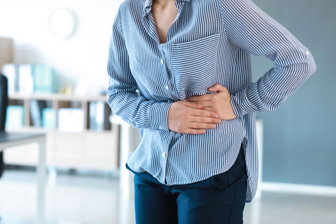 Patient holding upper left abdomen, where spleen pain is felt