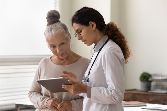 Doctor explaining blood test results to patient in office.