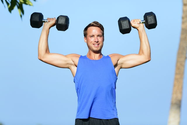 man performing shoulder press