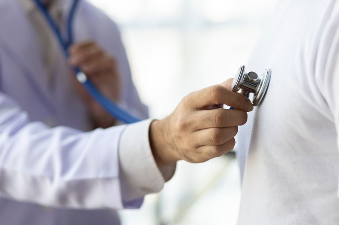 person at the cardiologist being auscultated