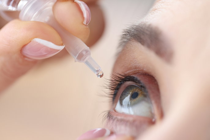 eye drops being squeezed into eye