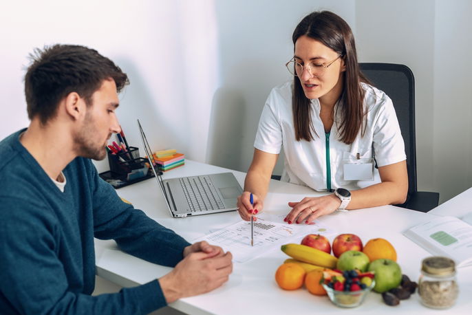 Doctor advising patient on weight loss diet