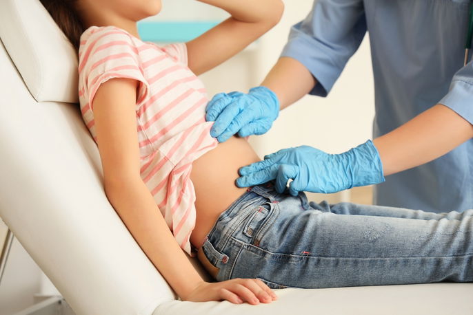 Doctor assessing appendicitis pain in right lower abdomen