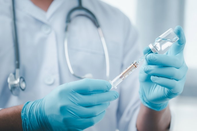 nurse pulling up a vaccine
