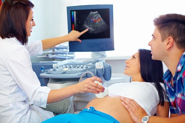 Doctor explaining ultrasound to couple