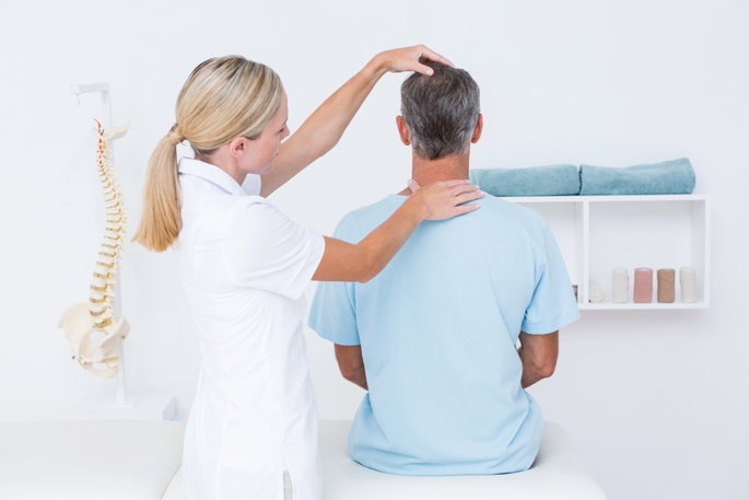 orthopedic specialist assessing patient's neck alignment