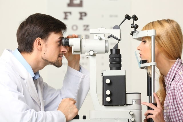ophthalmologist examining patient's eye