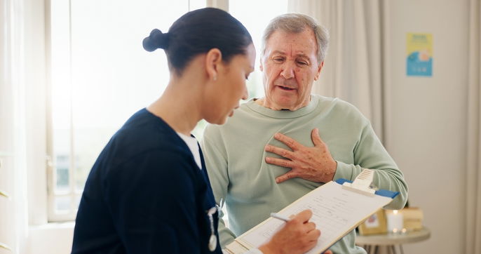 Man describing chest pain to nurse