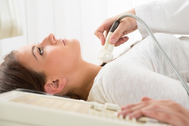 woman having thyroid ultrasound