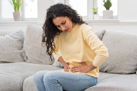 Illustrative image of the article Pain Below Belly Button: 9 Common Causes (& How to Treat)