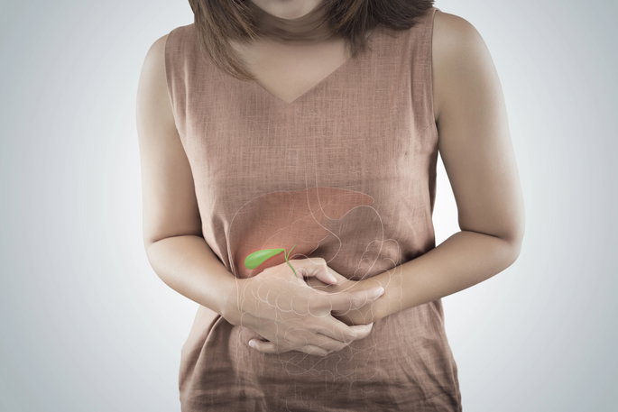 woman with hands on her abdomen with illustration of gallbladder superimposed