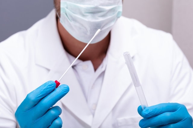 doctor performing a COVID test