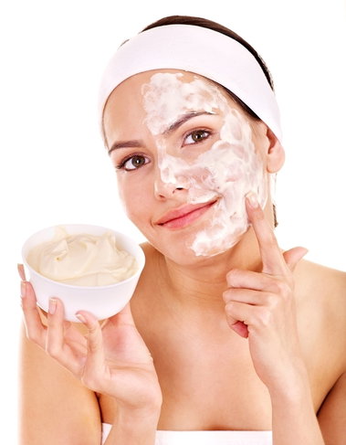 woman with cream applied to half of her face