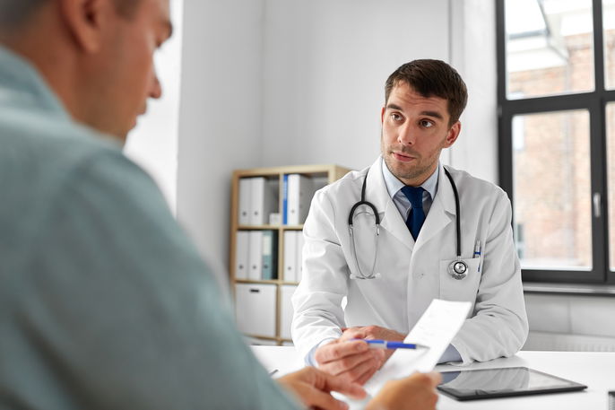 doctor talking to male patient