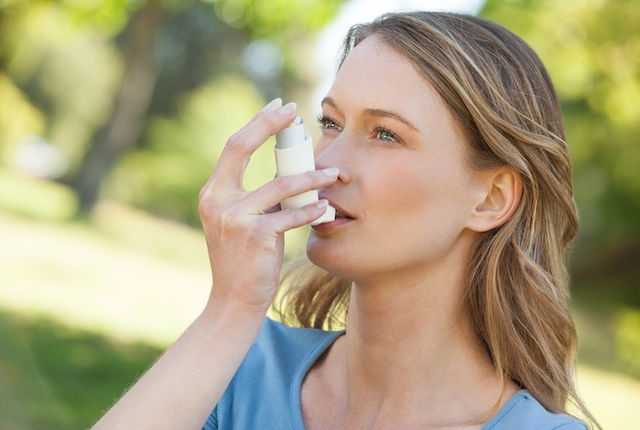woman using inhaler
