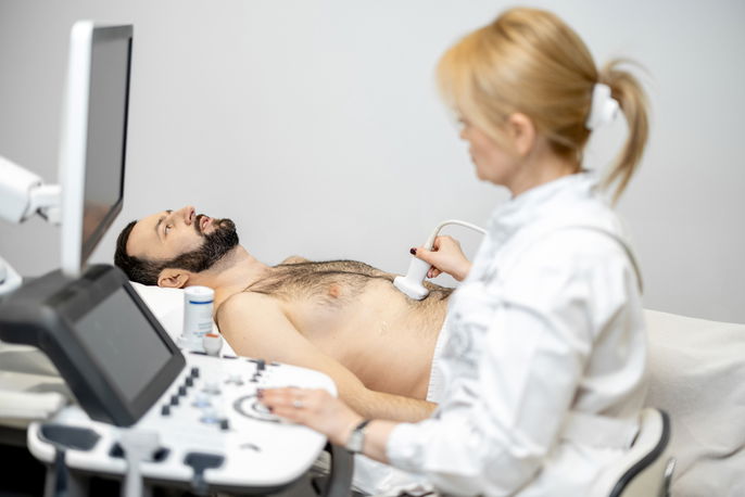 Technician performing liver ultrasound