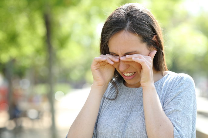 Woman rubbing eyes